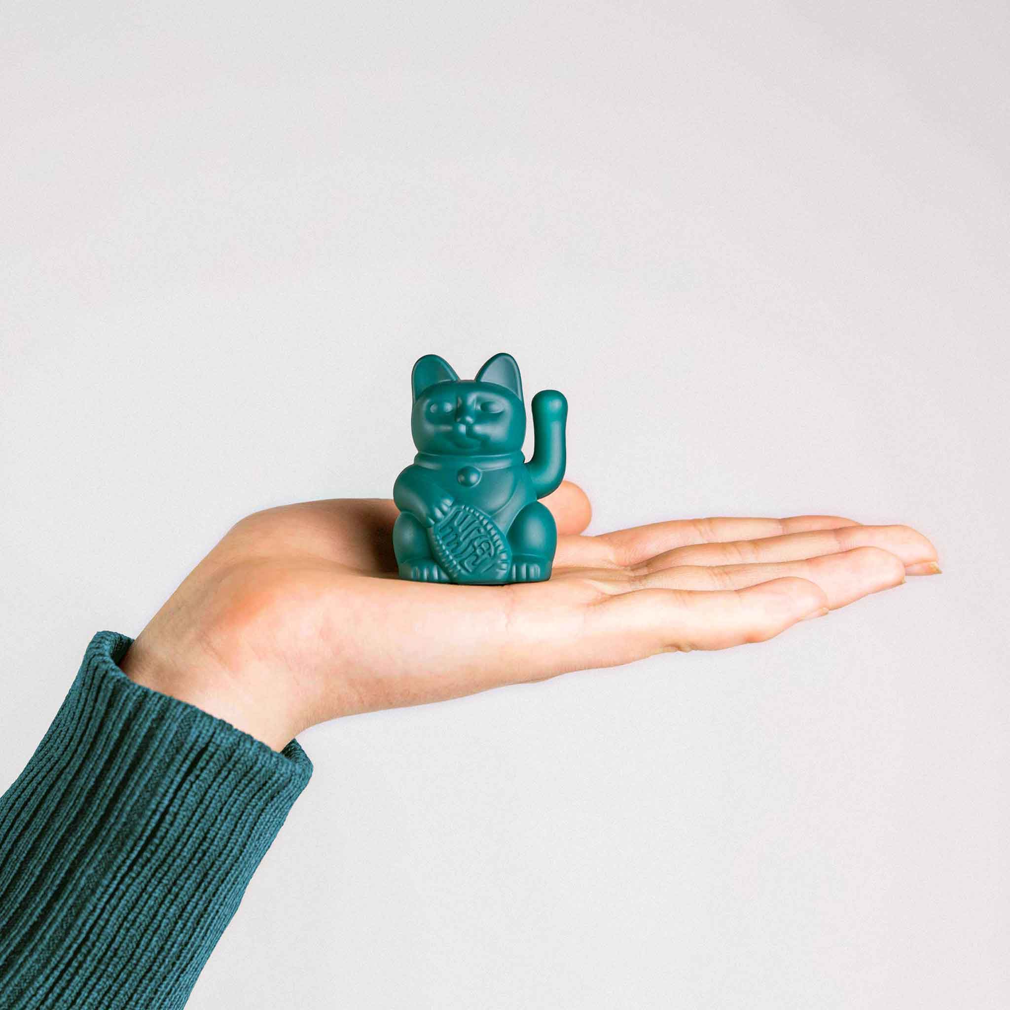 Winkekatze Solar in Grün auf einer Hand als Größenvergleich